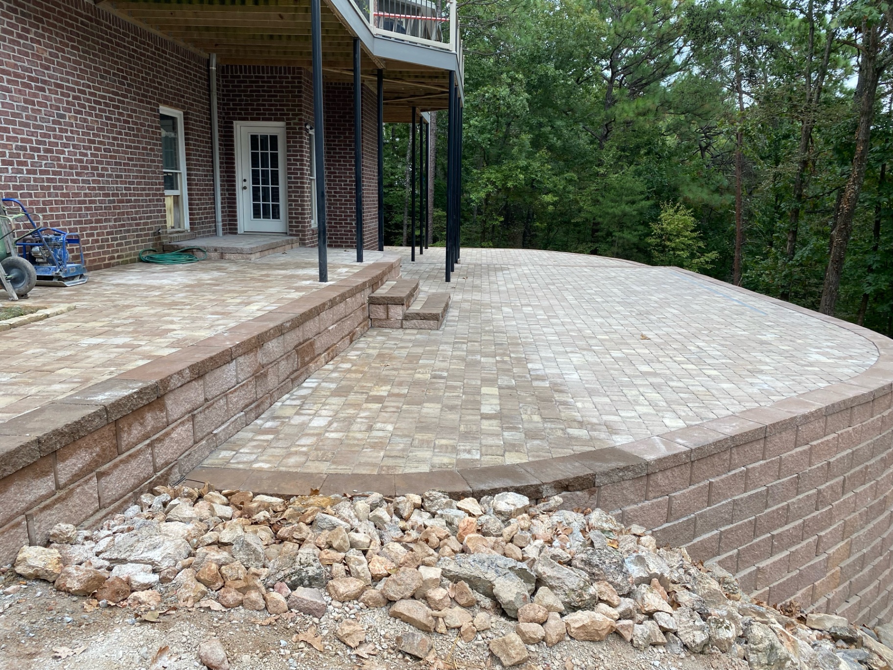 Raised paver patio with retaining wall and steps